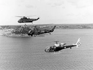 Three Royal Navy helicopters alongside St Michaels Mount