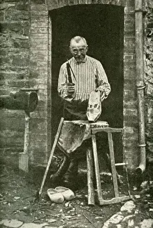 Sabot maker working at his cottage door, Belgium