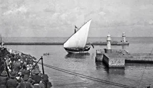 Lighthouses Prints: Sailing boat entering a harbour