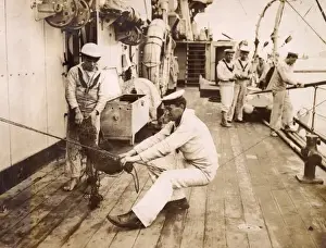 Sailor binding a swab, sitting on a rope, WW1