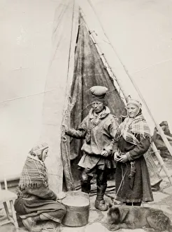 Sami people and their dog outside a tent Finnmarken, Norway