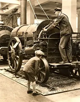 Stephenson Prints: Schoolboy inspects the Rocket locomotive