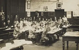 Midday Prints: Schoolchildren ear their midday meal at their desks. Date: early 20th century