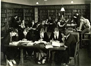 Schoolgirls in uniform studying in a library