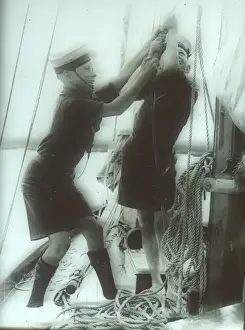 Hoist Prints: Two Sea Scouts hosting a sail on a ship