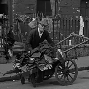 Barrow Gallery: Selling second hand clothes from a barrow, London