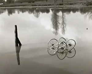 Ripples Prints: Set of old pram wheels in a pond