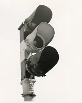 A set of traffic lights, looks like they're green but it's a black and white photo. Date: late 1960s