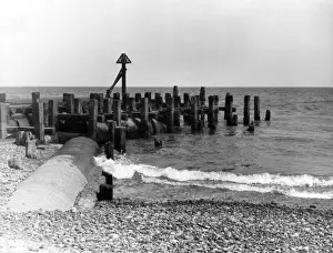 Sewage sluice pipes, the cause if sea pollution on the beach at Minsmere, Suffolk