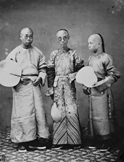Three shaven-headed men holding fans, China