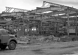 Framework Prints: Shell of a building with parked vehicles