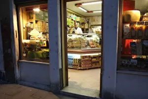 Grocer Gallery: Shopkeeper in delicatessen at night, Via Garibaldi, Venice