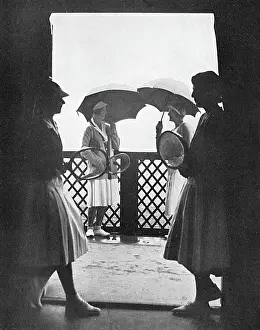 Doubles Prints: A shower during a tennis match, 1932