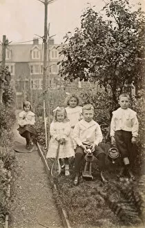 Siblings Collection: Five siblings playing in their suburban garden