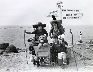 Fundraising Gallery: Signpost at Lands End, Cornwall, with charity walkers