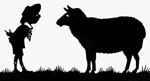 Silhouette of a boy with a sheep