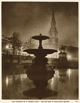 Silhouette of Trafalgar Square, London, on a wet winter night. Date: 1935