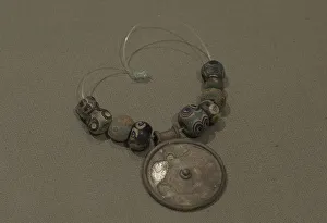 Earthenware Prints: Silver medallion and faience eye beads