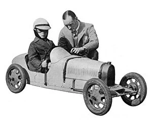 Records Gallery: Sir Malcolm Campbell & Donald Campbell in toy motor car
