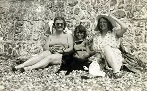 Aunt Collection: Sitting against a stone wall on a pebbly beach