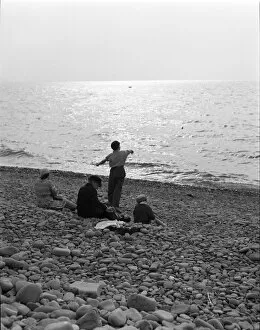 Images Dated 4th December 2009: Skimming stones on a pebble beach