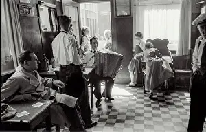 Small band playing in daylight at local bar at Cafe In de Ton de Koninck in Katten Straat Antwerp-shows accordion + saxophone and people young and old sitting and milling Date