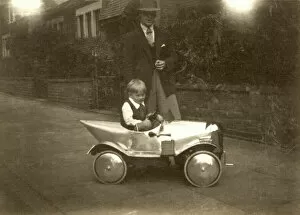 Sepia Collection: Small boy with chrome shiny silver pedal car