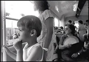 Small boy lady with fan on bus, Valencia, Spain