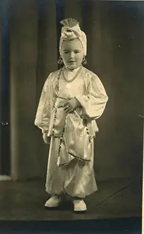 Harem Prints: A small boy (or girl) dressed in a turban and harem pants in an Arabian Nights style