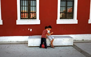 Two small boys look in the Placa de s'Esplanada, Es Castell