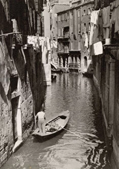 A small back canal, Venice, Italy - A local man off shopping