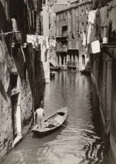 Poling Prints: A small back canal, Venice, Italy - A local man off shopping