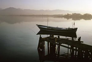 Images Dated 27th August 2019: Small fishing boat lies moored off old wooden jetty, Fetheye