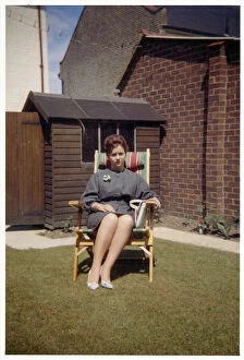 Images Dated 3rd February 2021: Smart young lady - suburban garden - comfy garden chair
