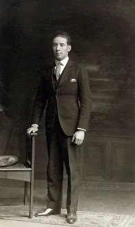 Stiff Prints: Smart young man posing for a Studio photograph