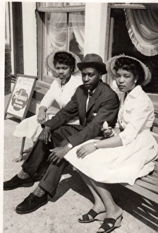 Images Dated 19th July 2016: Three smartly dressed British Caribbean people sitting on be