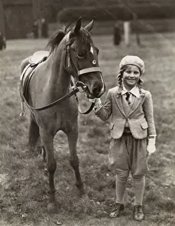 Plaited Prints: Smiling girl with her pony in a field