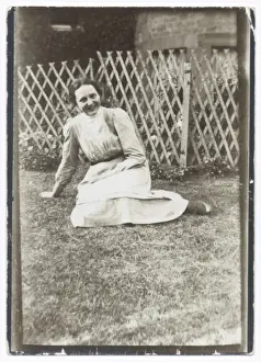 Smiling woman sitting on a lawn