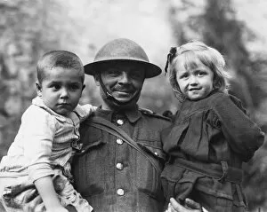 WWI Soldiers Gallery: Soldier with two refugee children, Tournai, Flanders, WW1