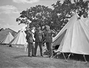 Three soldiers at a camp