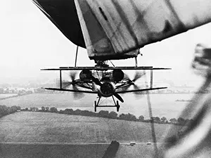 Sopwith Prints: Sopwith Camel Biplane Hanging under a R23 Airship Flying