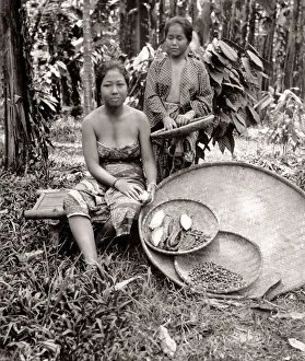 South East Asia - women with baskets of crop of fruit