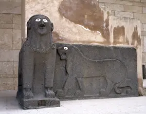 Sphinx and a lion in relief. Basalt. Syria