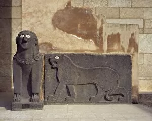 Neolithic Gallery: Sphinx and a lion in relief. Basalt. Syria