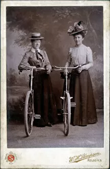 Images Dated 17th February 2020: A splendid cabinet photograph of two well-dressed women standing proudly with their bicycles