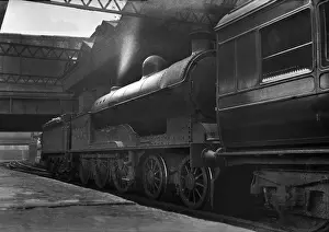 Steam engine with carriage in railway station