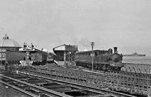 Steam engine and carriages at a coastal station