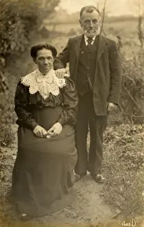 Severe Prints: Stern elderly British couple pose for an outdoor portrait