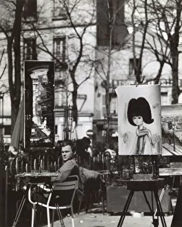 Street artist and paintings in the Place du Tertre, Paris