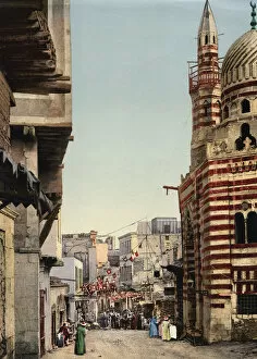 Street scene with mosque and minarets, Cairo